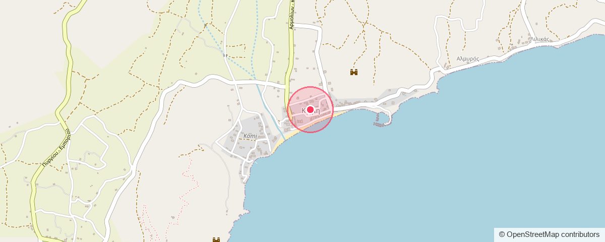 Map of Komi on the south-east coast of Chios: the village sits just inland of its bay, with the beach along the shore.